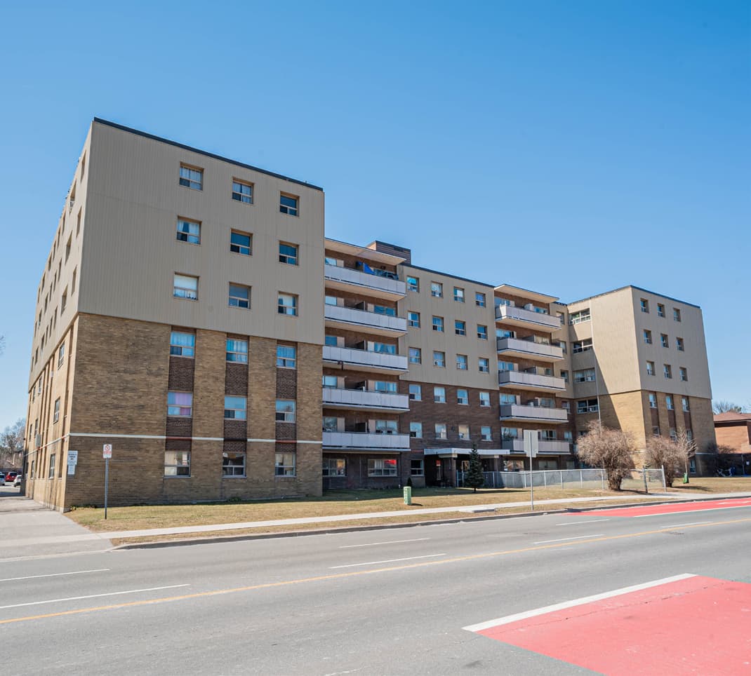 The Morningside Avenue elevation of 290 Morningside, a six-storey brick and metal-panel apartment building with continuous balconies